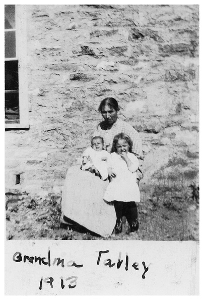 Mary Luisa Grisham Talley with two grandchildren, Mark Wallace on her lap with Emma Edith McPherson standing. Although the photo says 1913, it was probably summer of 1915. In 1915 Mark would have been one year old, and Edith three years old. On the back of the photo it does not say which child is which. Mark's mother, Agnes was Floy's sister. 00012.jpg